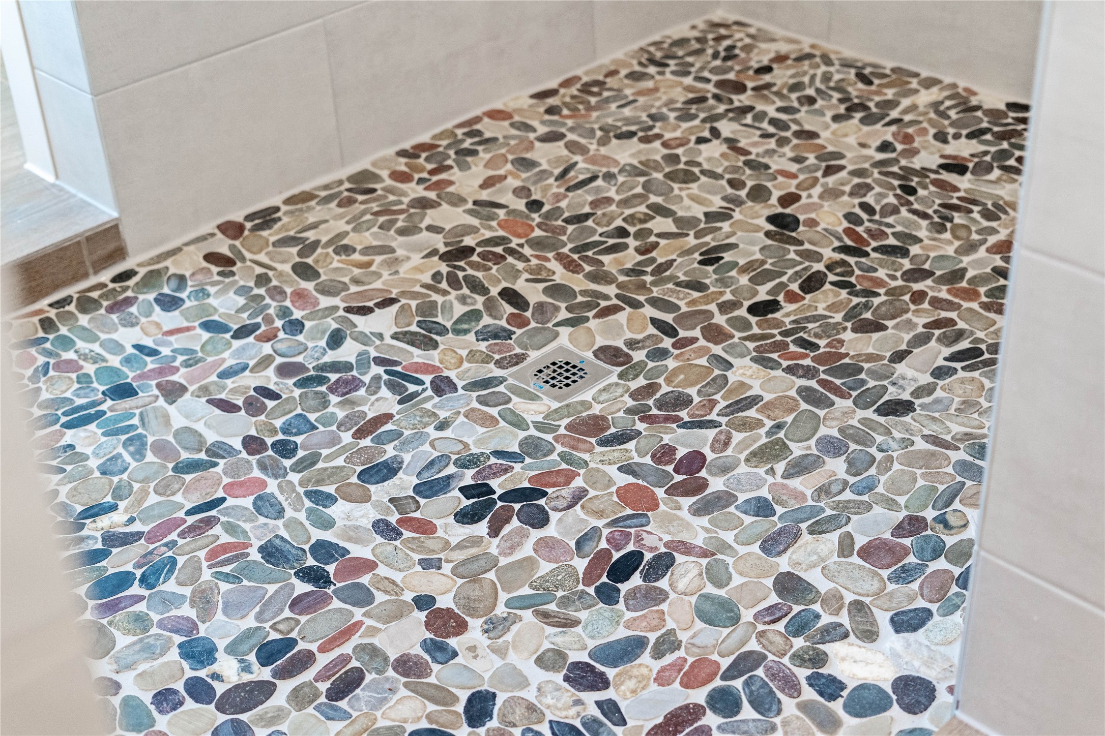 2114 Rowl Street Montgomery, TX 77316 - Photo 37 of 50 The walk-in shower features this stunning natural river rock pebble floor. The multicolored stones provide an organic, textured feel underfoot while creating a beautiful visual focal point.