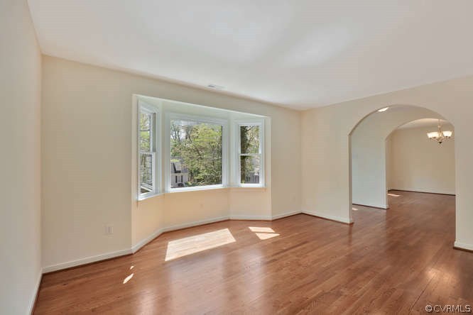 5700 North Chase Road Midlothian, VA 23112 - Photo 6 of 30 an empty room with wooden floor and windows