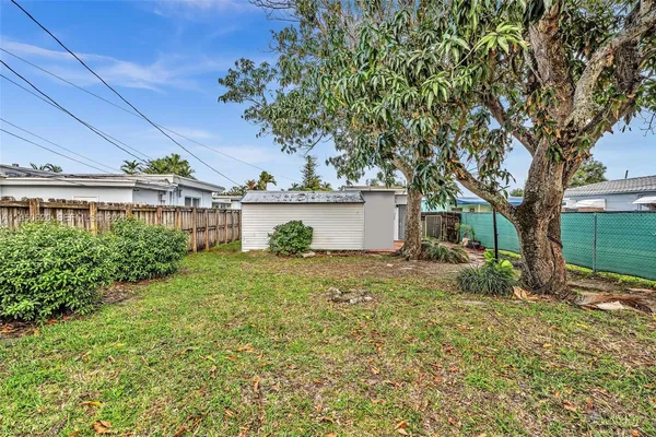 a view of a house with yard and a tree