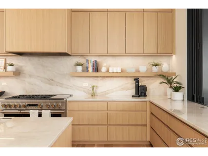 a kitchen with stainless steel appliances granite countertop white cabinets stove and sink