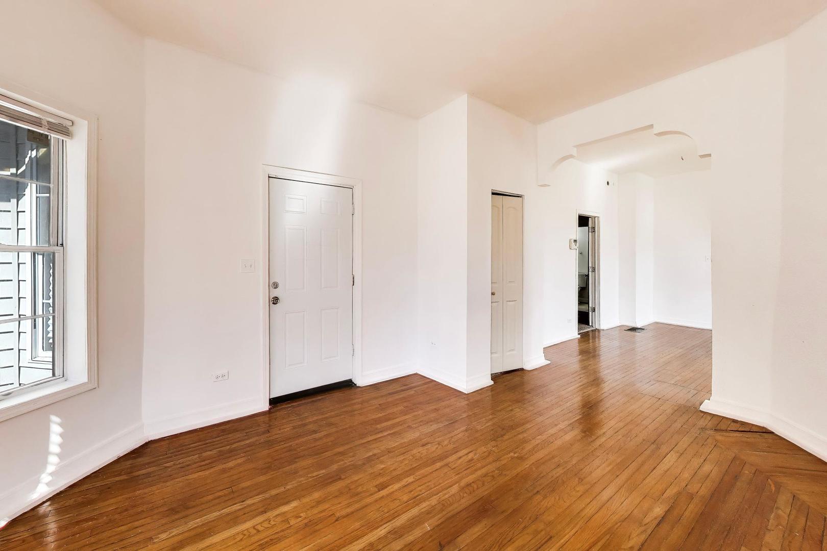 6853 South Perry Avenue Chicago, IL 60621 - Photo 5 of 28 a view of empty room with wooden floor