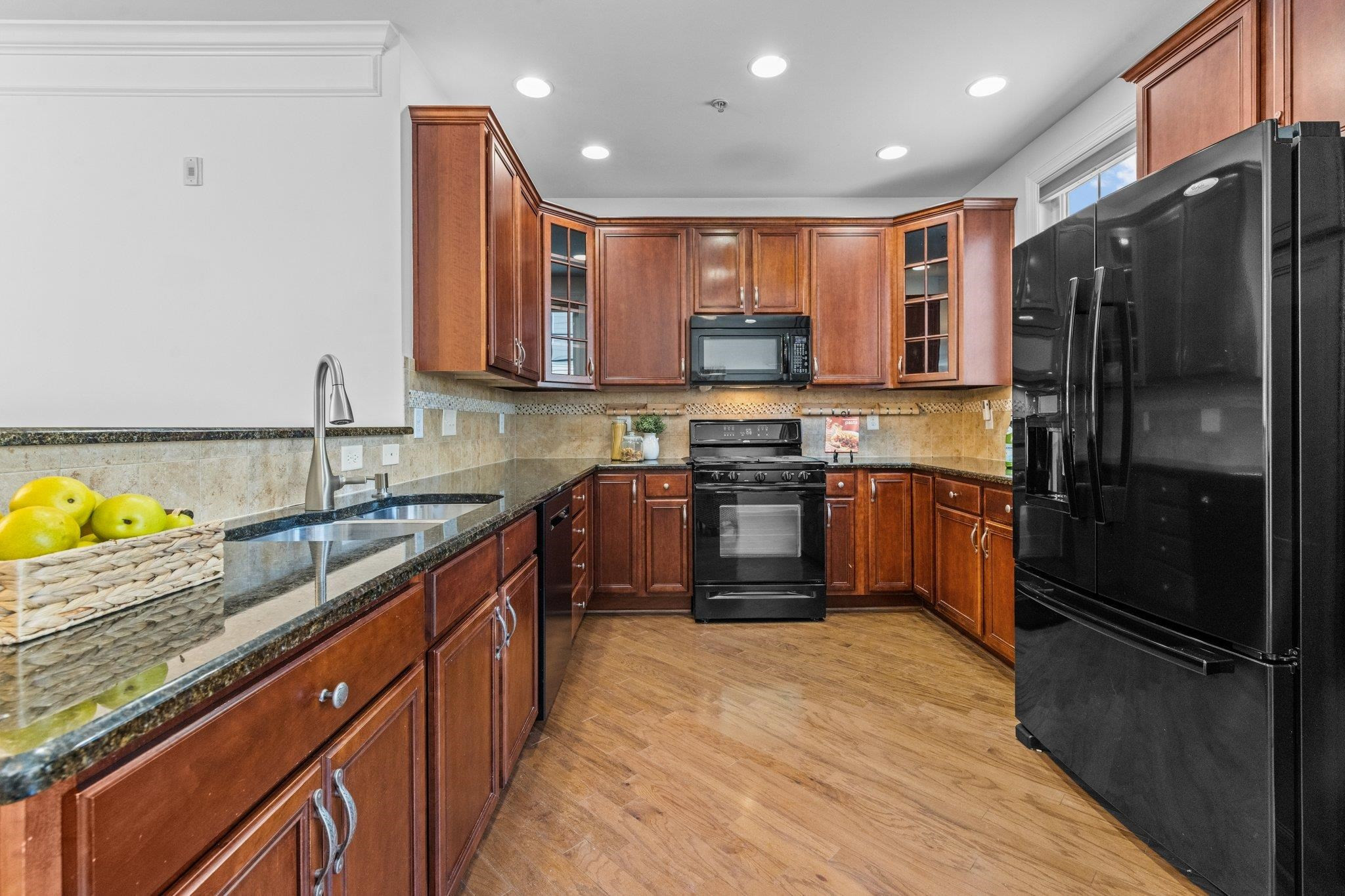 10321 Sablewood Drive, Unit 109 Raleigh, NC 27617 - Photo 11 of 47 a kitchen with stainless steel appliances granite countertop a stove a sink dishwasher a refrigerator and a microwave oven with wooden cabinets