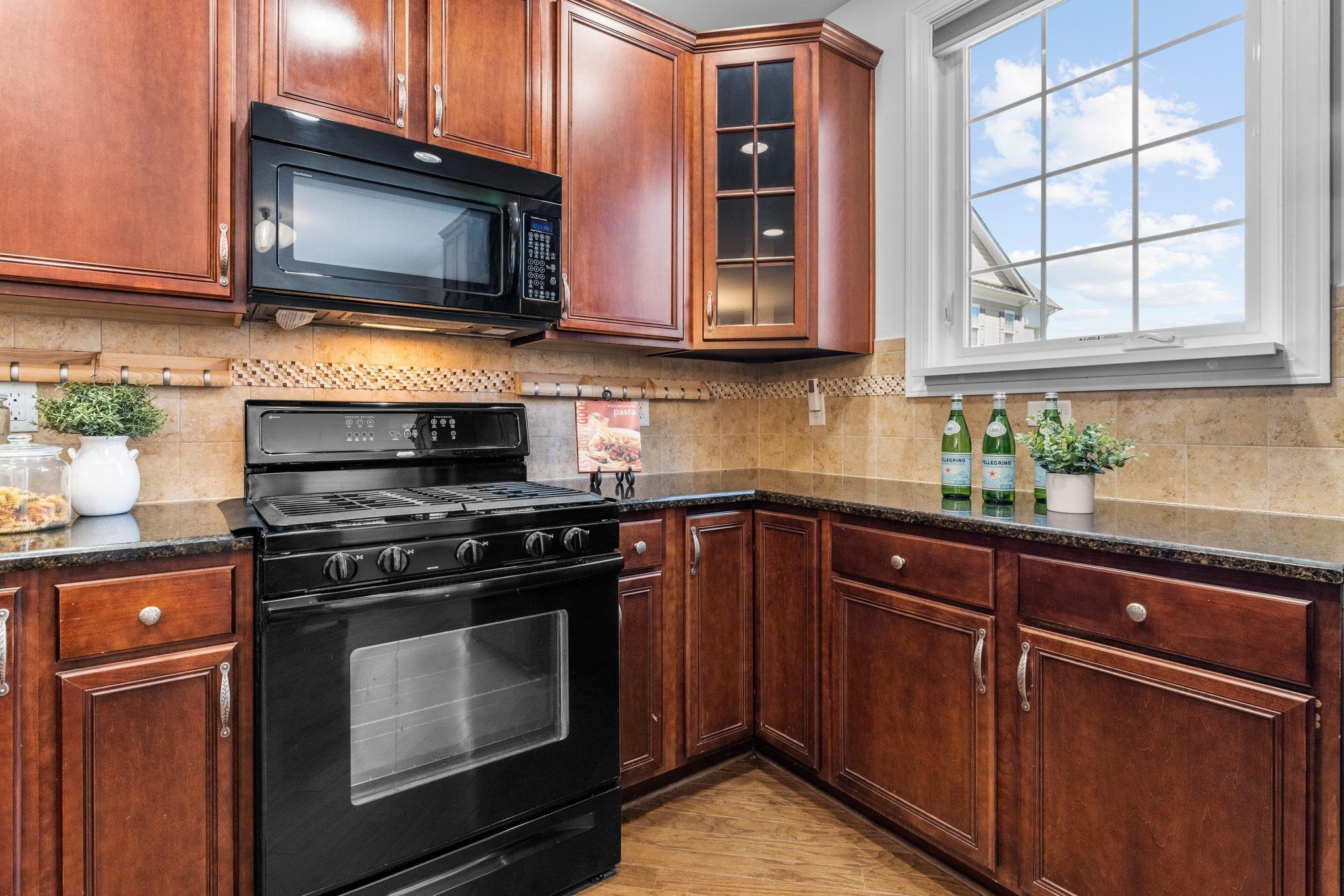 10321 Sablewood Drive, Unit 109 Raleigh, NC 27617 - Photo 13 of 47 a kitchen with stainless steel appliances granite countertop a stove microwave and cabinets