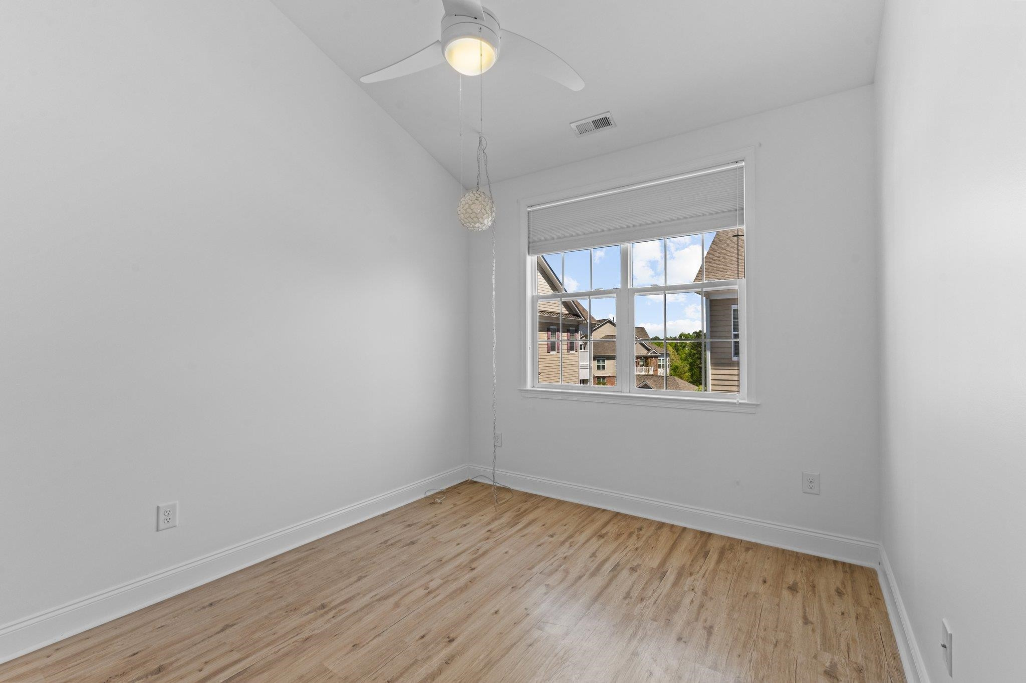 10321 Sablewood Drive, Unit 109 Raleigh, NC 27617 - Photo 26 of 47 an empty room with wooden floor and windows