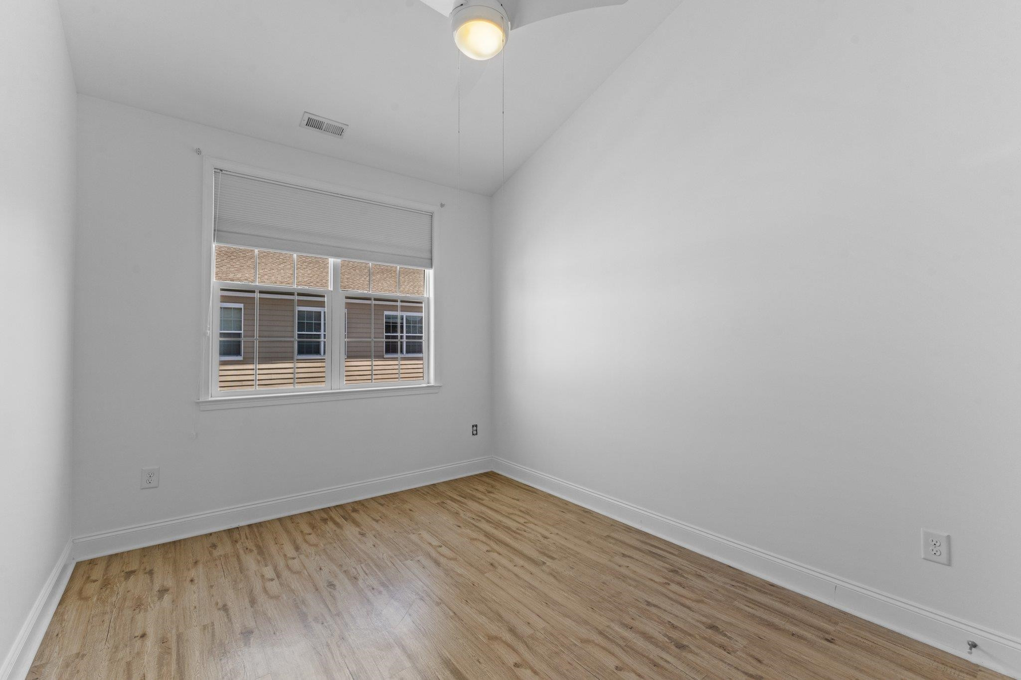10321 Sablewood Drive, Unit 109 Raleigh, NC 27617 - Photo 27 of 47 a view of empty room with wooden floor and fan