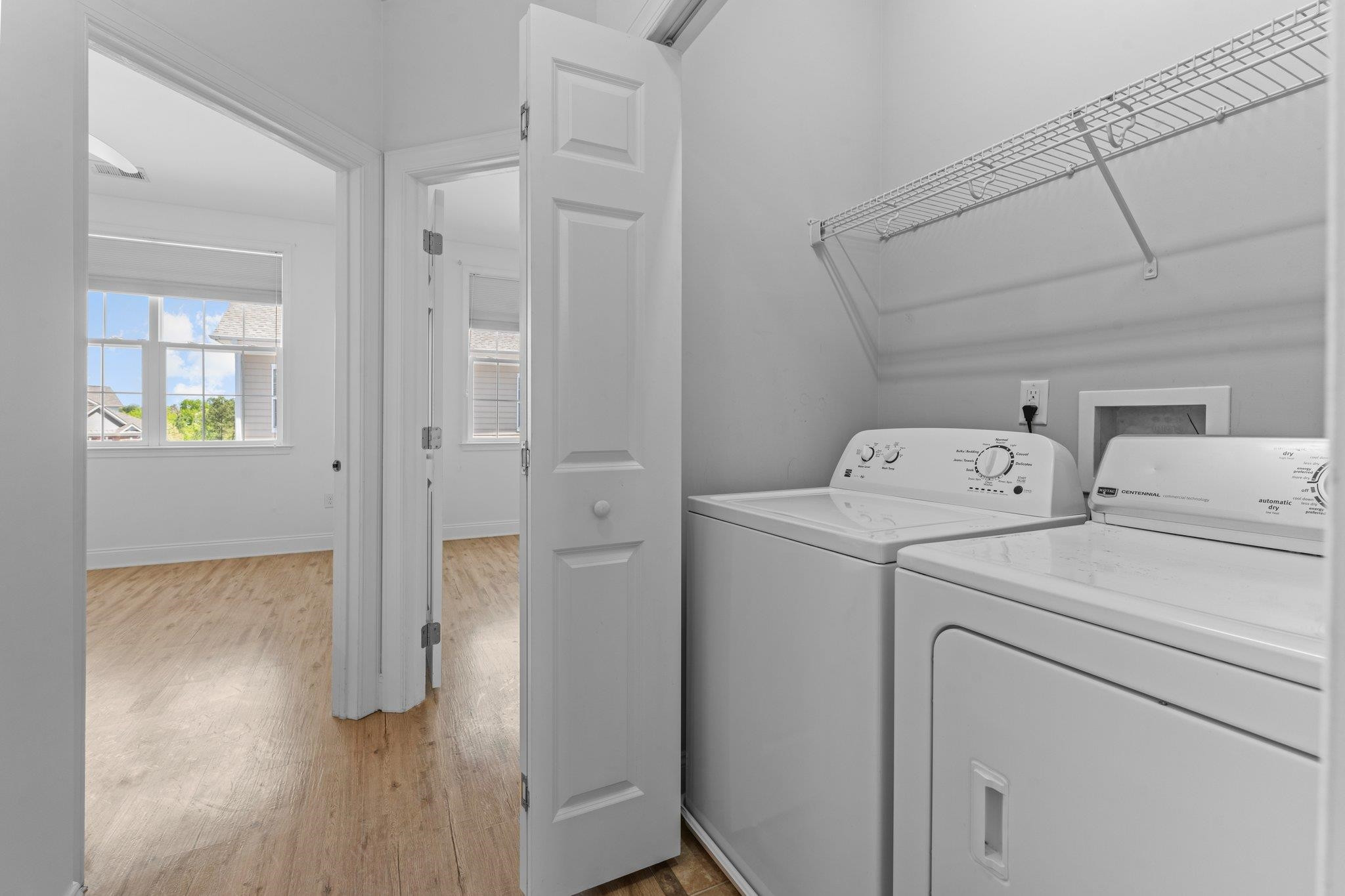 10321 Sablewood Drive, Unit 109 Raleigh, NC 27617 - Photo 29 of 47 a view of washer and dryer with bathroom in the background