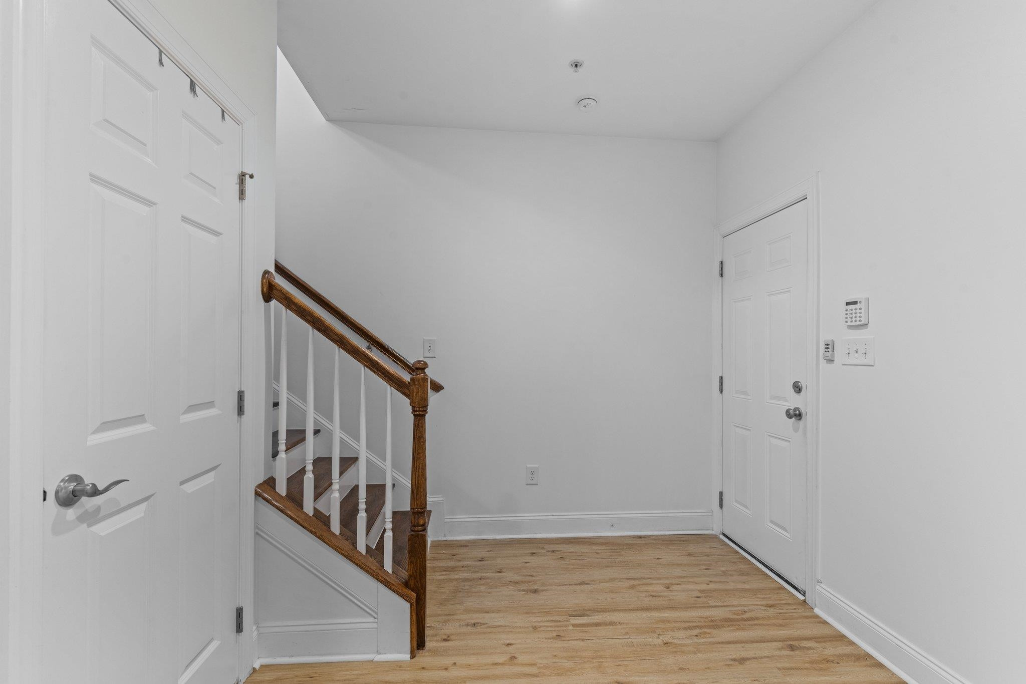 10321 Sablewood Drive, Unit 109 Raleigh, NC 27617 - Photo 30 of 47 a view of a hallway with wooden floor and staircase