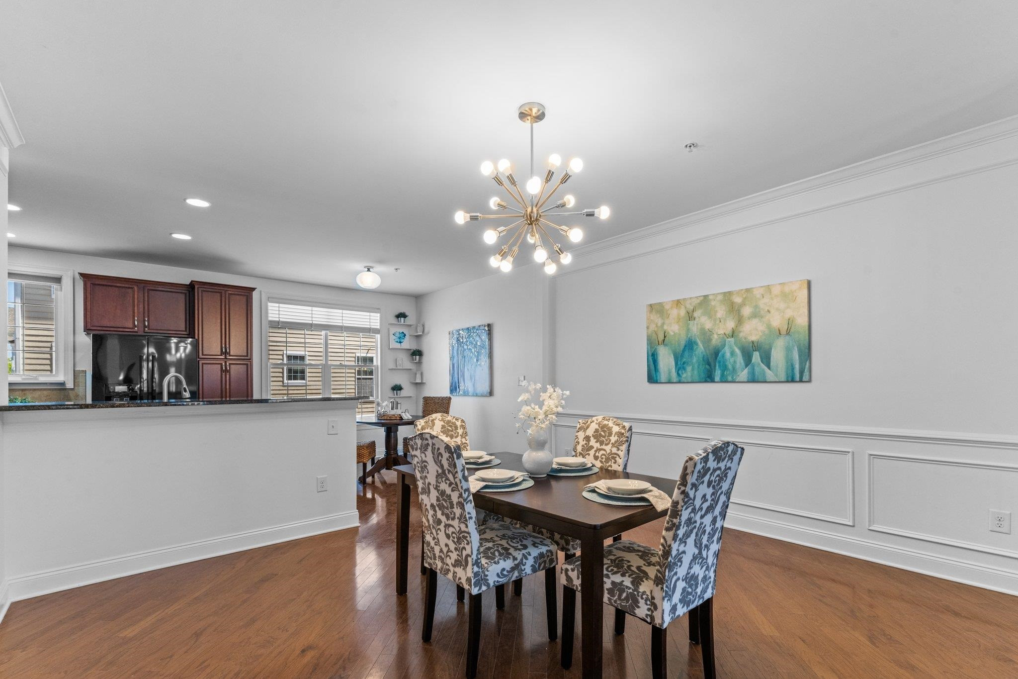 10321 Sablewood Drive, Unit 109 Raleigh, NC 27617 - Photo 7 of 47 a view of a dining room with furniture and wooden floor