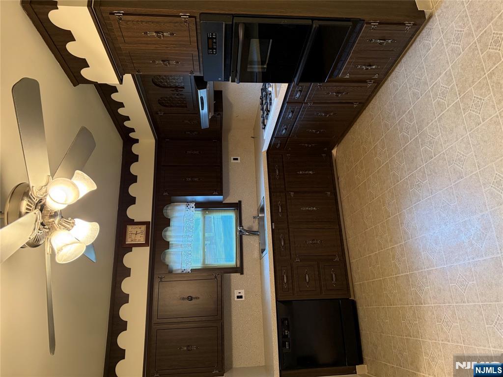 419 Elm Street, Unit 2 Kearny, NJ 07032 - Photo 4 of 8 a kitchen with stainless steel appliances granite countertop a sink and cabinets