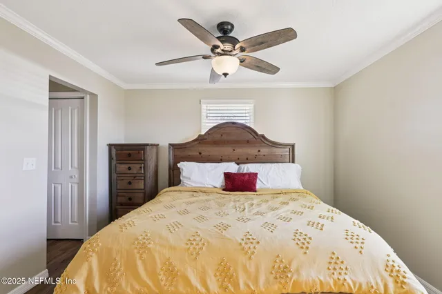 a bedroom with a bed and a ceiling fan