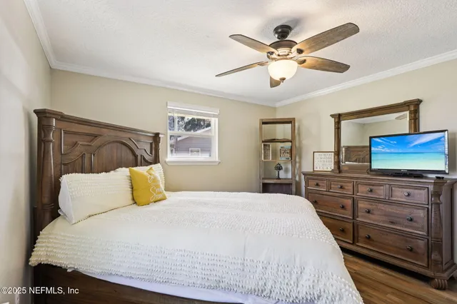 a bedroom with a large bed and a flat screen tv