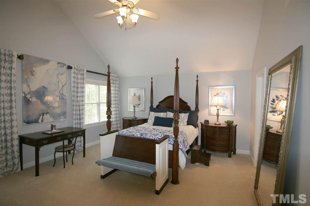7334 Fontana Ridge Lane Raleigh, NC 27613 - Photo 13 of 24 a bedroom with a bed a desk and chair with the wooden floor