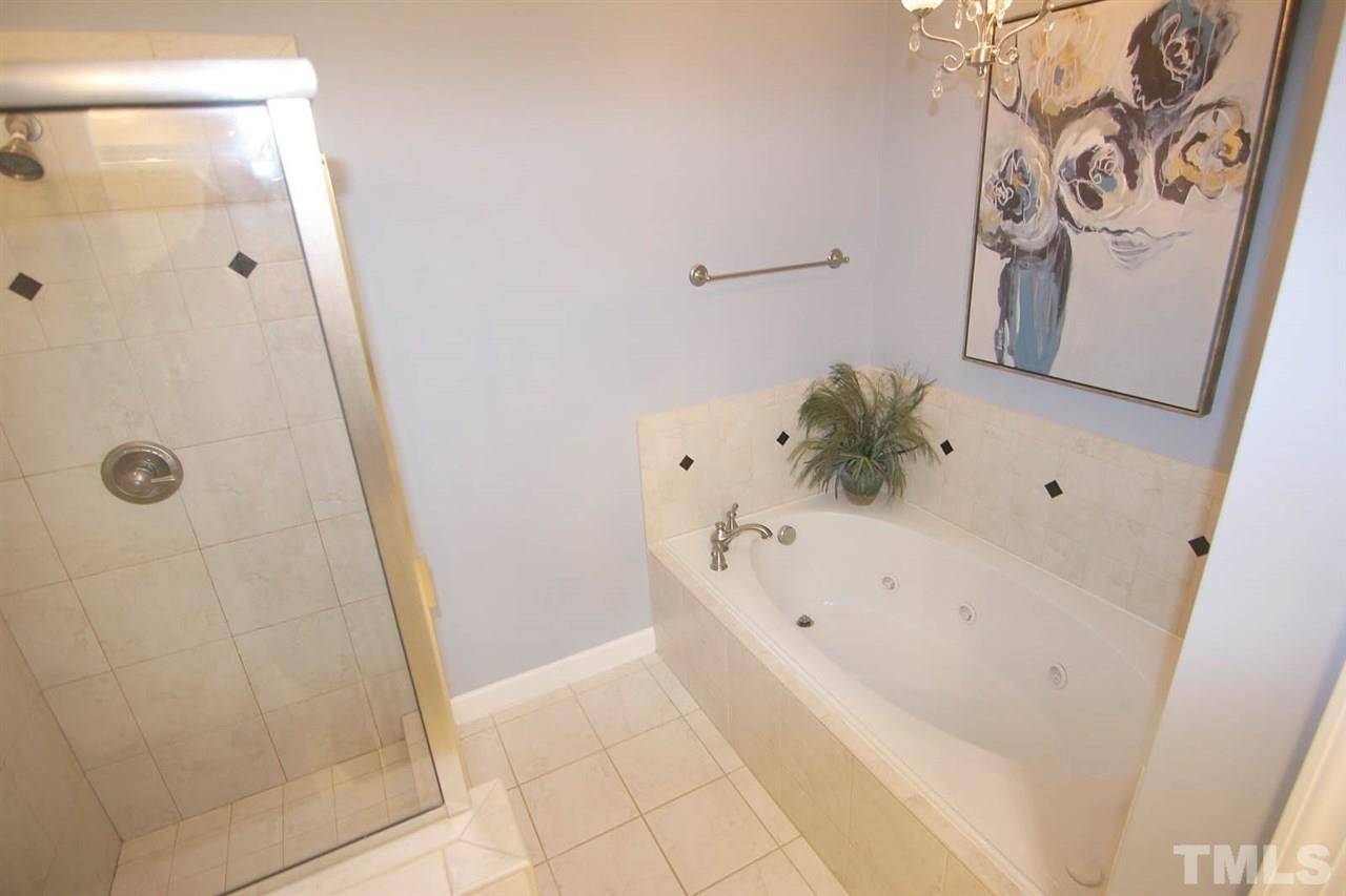 7334 Fontana Ridge Lane Raleigh, NC 27613 - Photo 16 of 24 a bathroom with a bathtub and shower