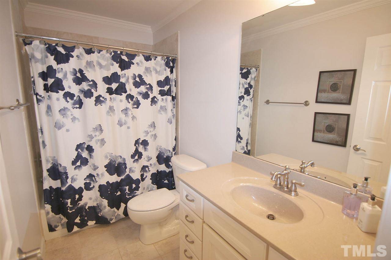 7334 Fontana Ridge Lane Raleigh, NC 27613 - Photo 21 of 24 a bathroom with a sink and mirror with toilet