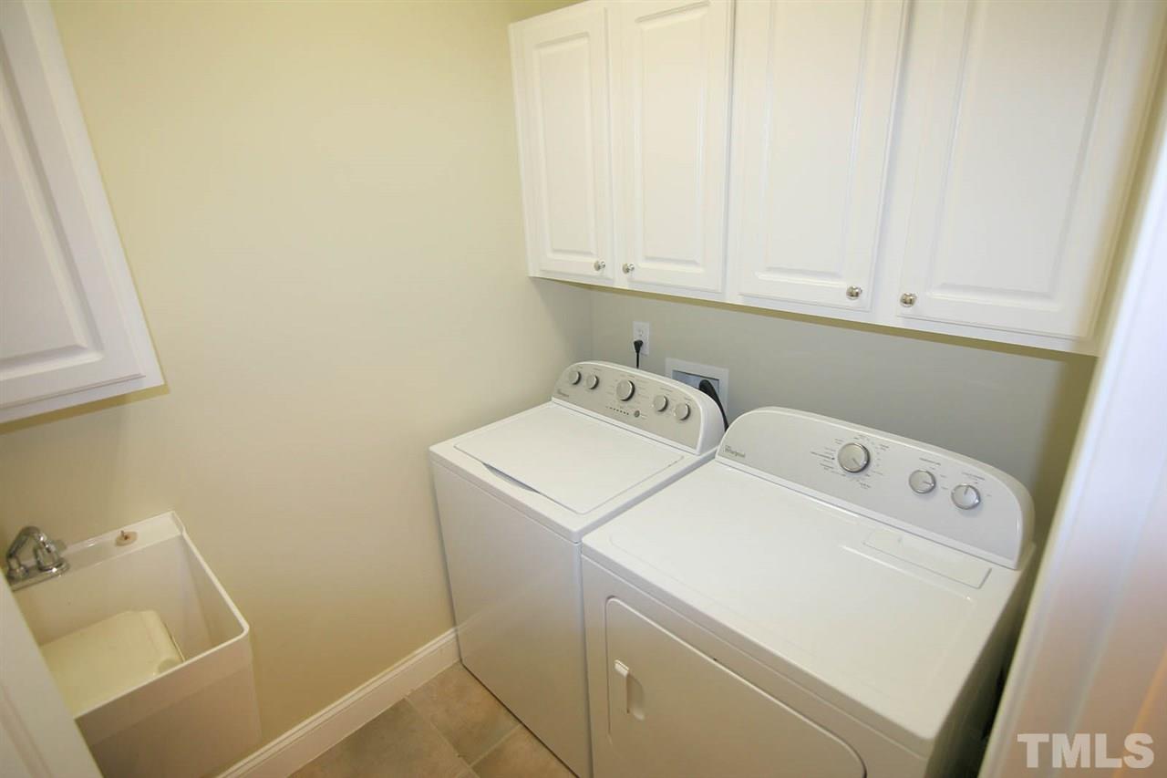 7334 Fontana Ridge Lane Raleigh, NC 27613 - Photo 22 of 24 a utility room with dryer and washer