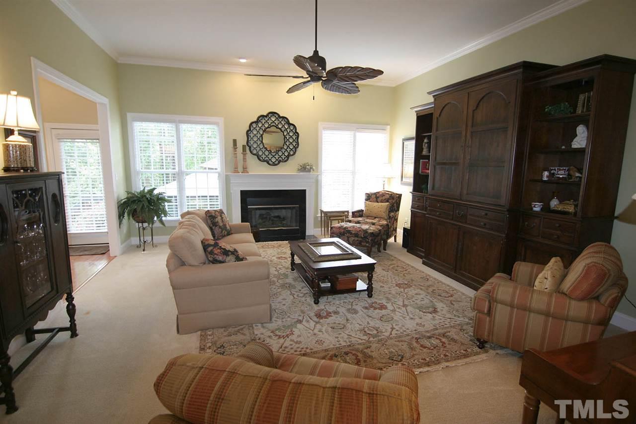 7334 Fontana Ridge Lane Raleigh, NC 27613 - Photo 5 of 24 a living room with furniture a window and a fireplace