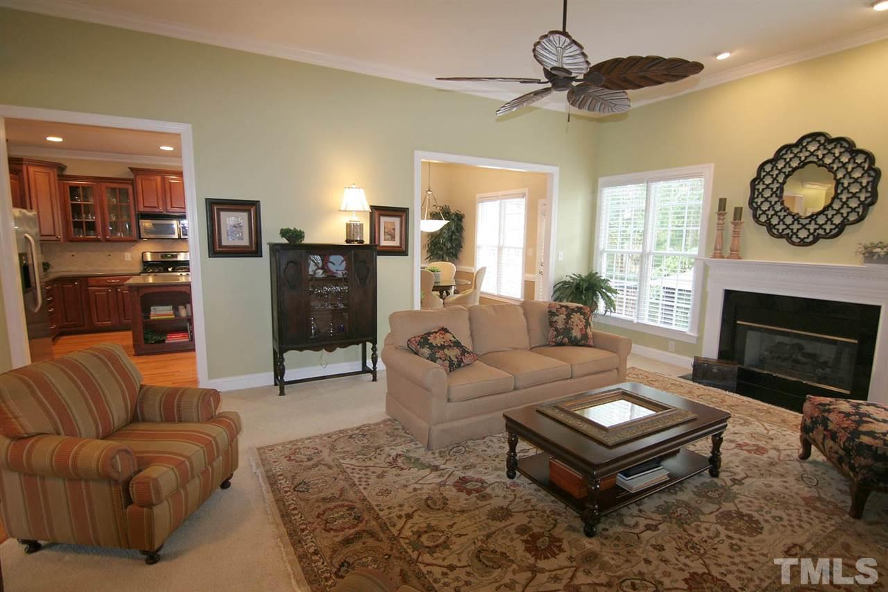7334 Fontana Ridge Lane Raleigh, NC 27613 - Photo 7 of 24 a living room with furniture a window and a fireplace