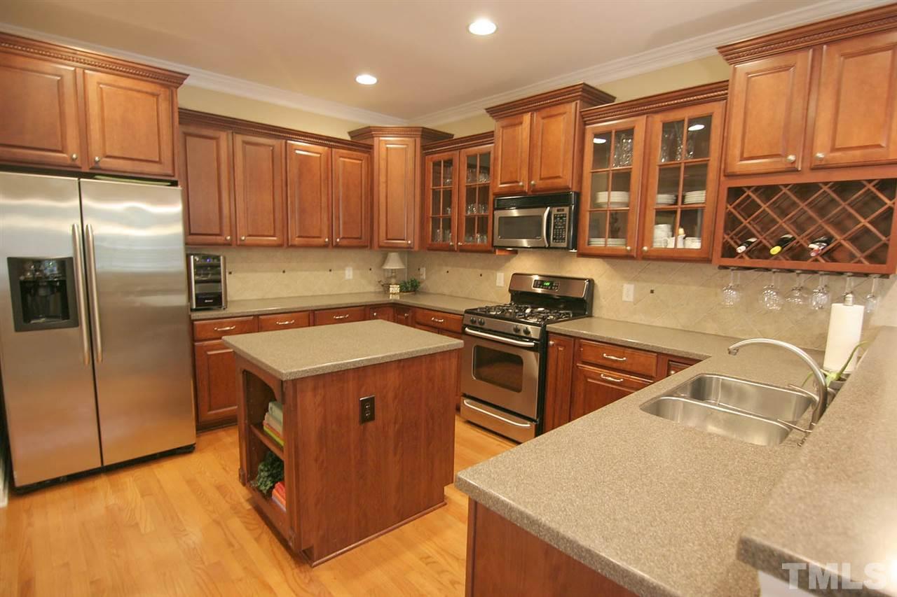 7334 Fontana Ridge Lane Raleigh, NC 27613 - Photo 8 of 24 a kitchen that has a sink a stove and a refrigerator