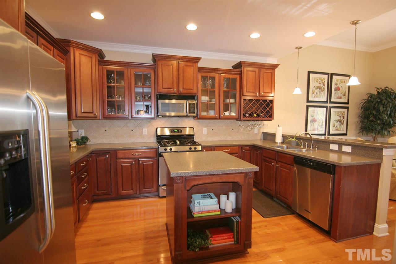 7334 Fontana Ridge Lane Raleigh, NC 27613 - Photo 9 of 24 a kitchen with stainless steel appliances granite countertop a sink stove and refrigerator