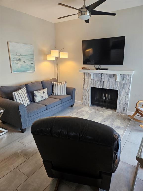 Undisclosed Address Madeira Beach, FL 33708 - Photo 2 of 35 a bedroom with a bed a flat screen tv and a fireplace