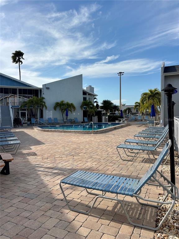 Undisclosed Address Madeira Beach, FL 33708 - Photo 26 of 35 a view of a porch with a table and chairs