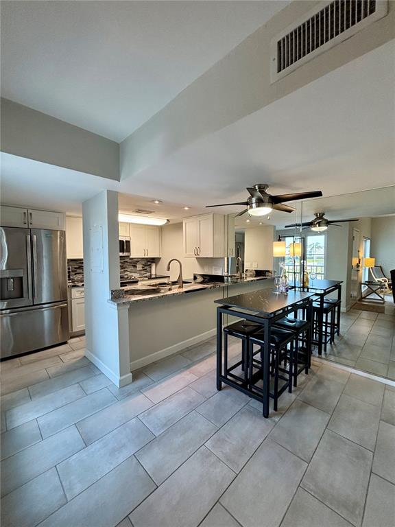 Undisclosed Address Madeira Beach, FL 33708 - Photo 5 of 35 a kitchen with granite countertop a counter top space and stainless steel appliances