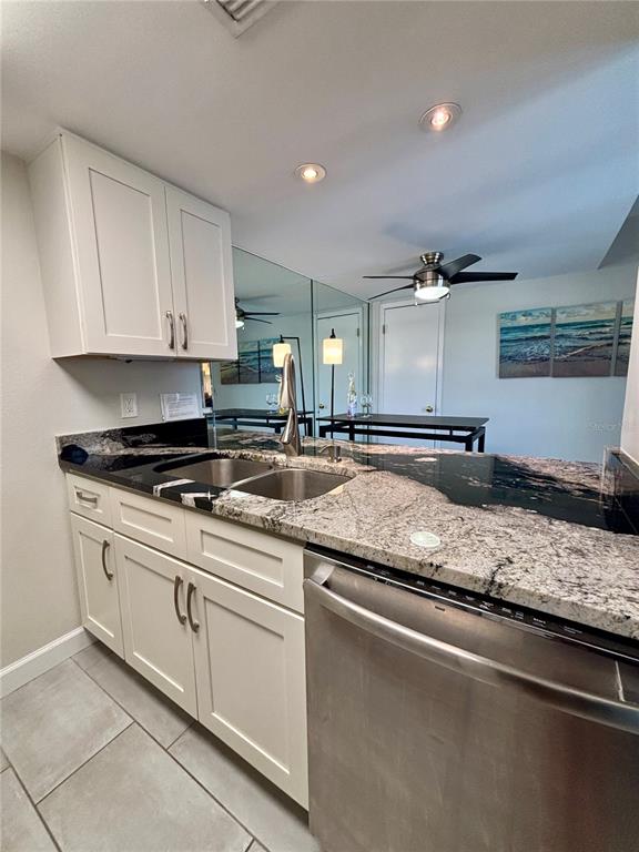 Undisclosed Address Madeira Beach, FL 33708 - Photo 9 of 35 a kitchen with stainless steel appliances granite countertop a sink stove and cabinets