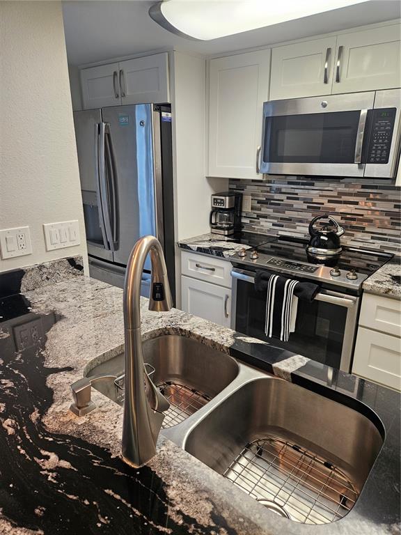 Undisclosed Address Madeira Beach, FL 33708 - Photo 10 of 35 a kitchen with a sink and a stove top oven
