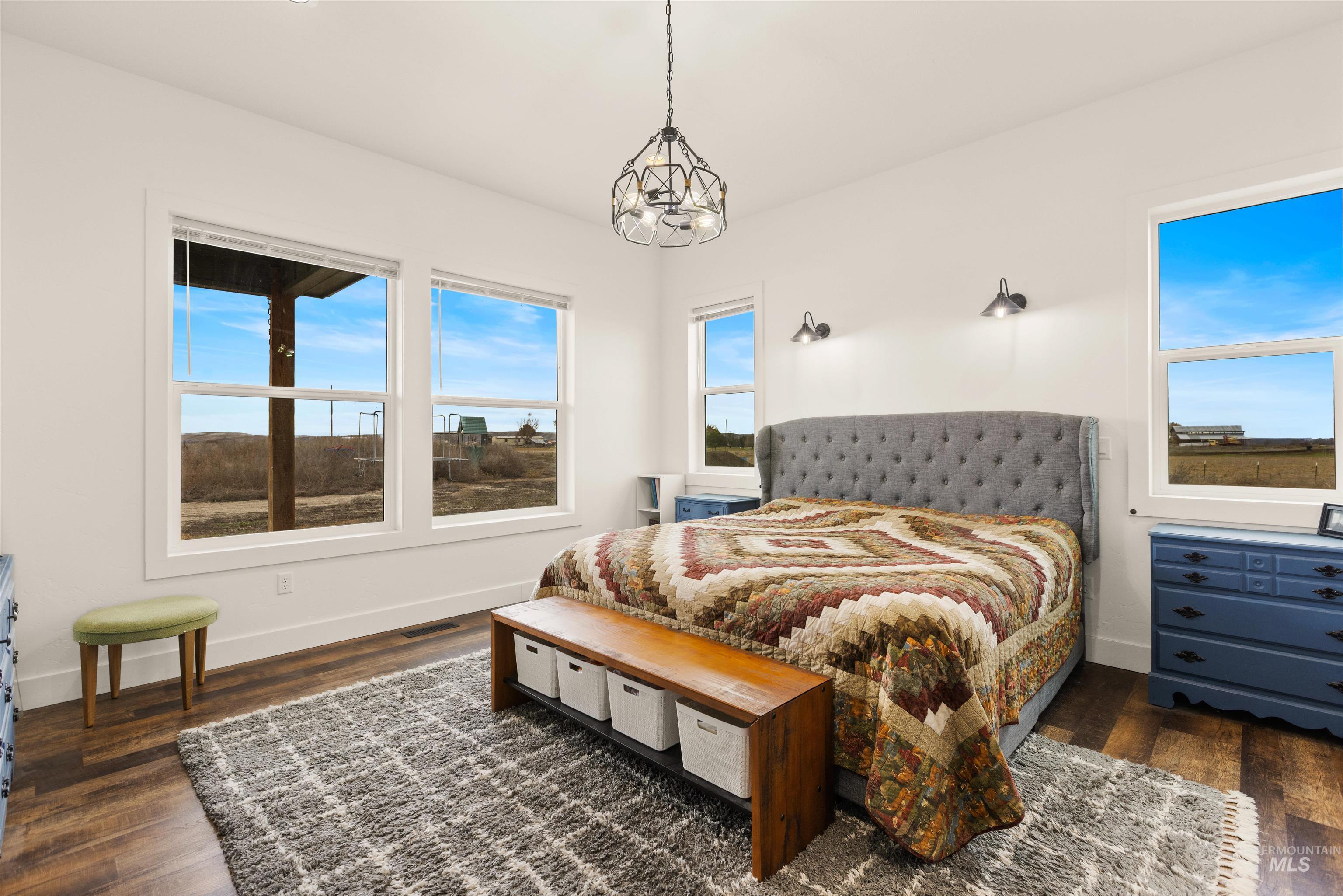 5220 West Central Road Emmett, ID 83617 - Photo 24 of 50 Bedroom with dark wood-style floors and hanging lights