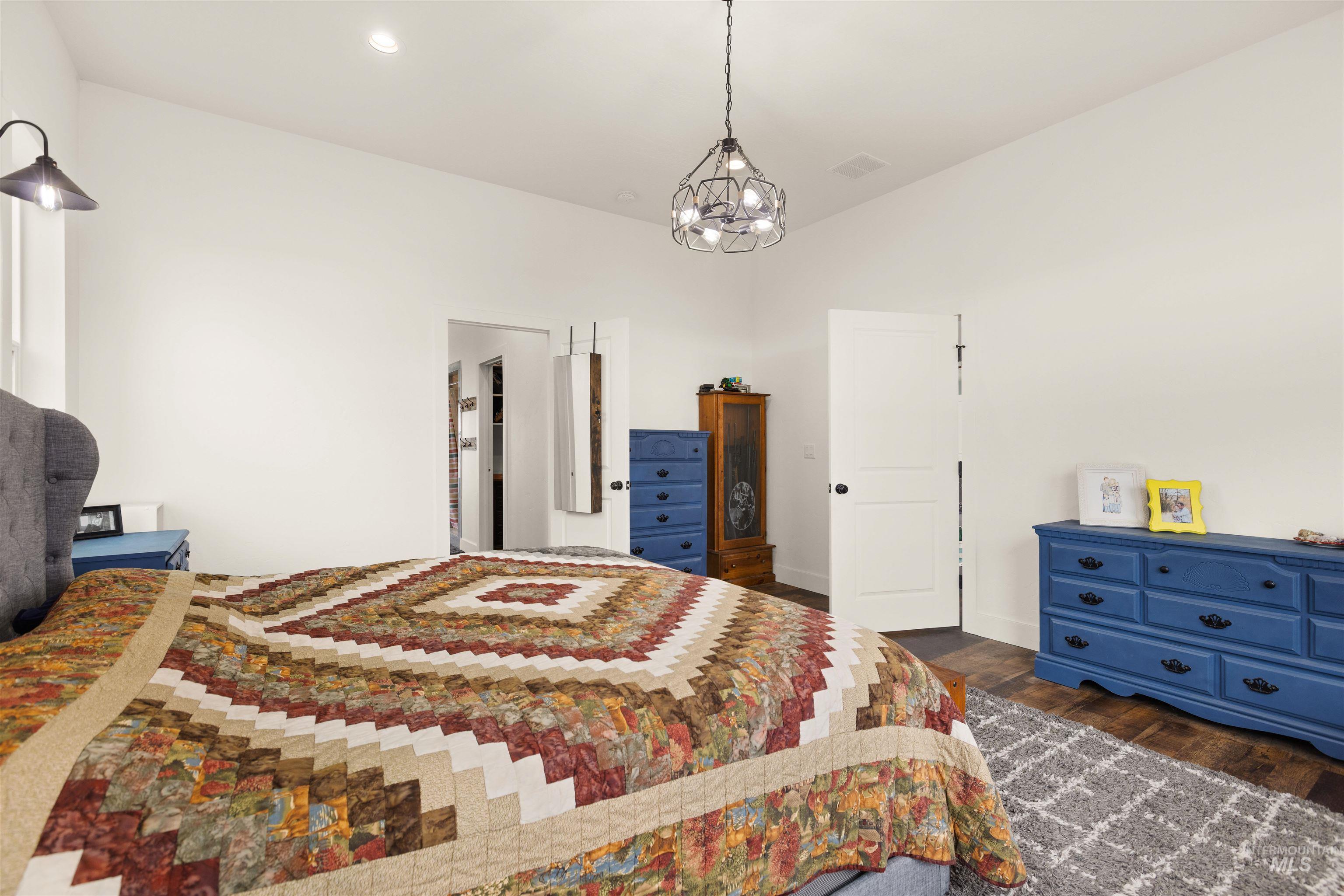 5220 West Central Road Emmett, ID 83617 - Photo 25 of 50 Bedroom with dark wood-type flooring and hanging lights