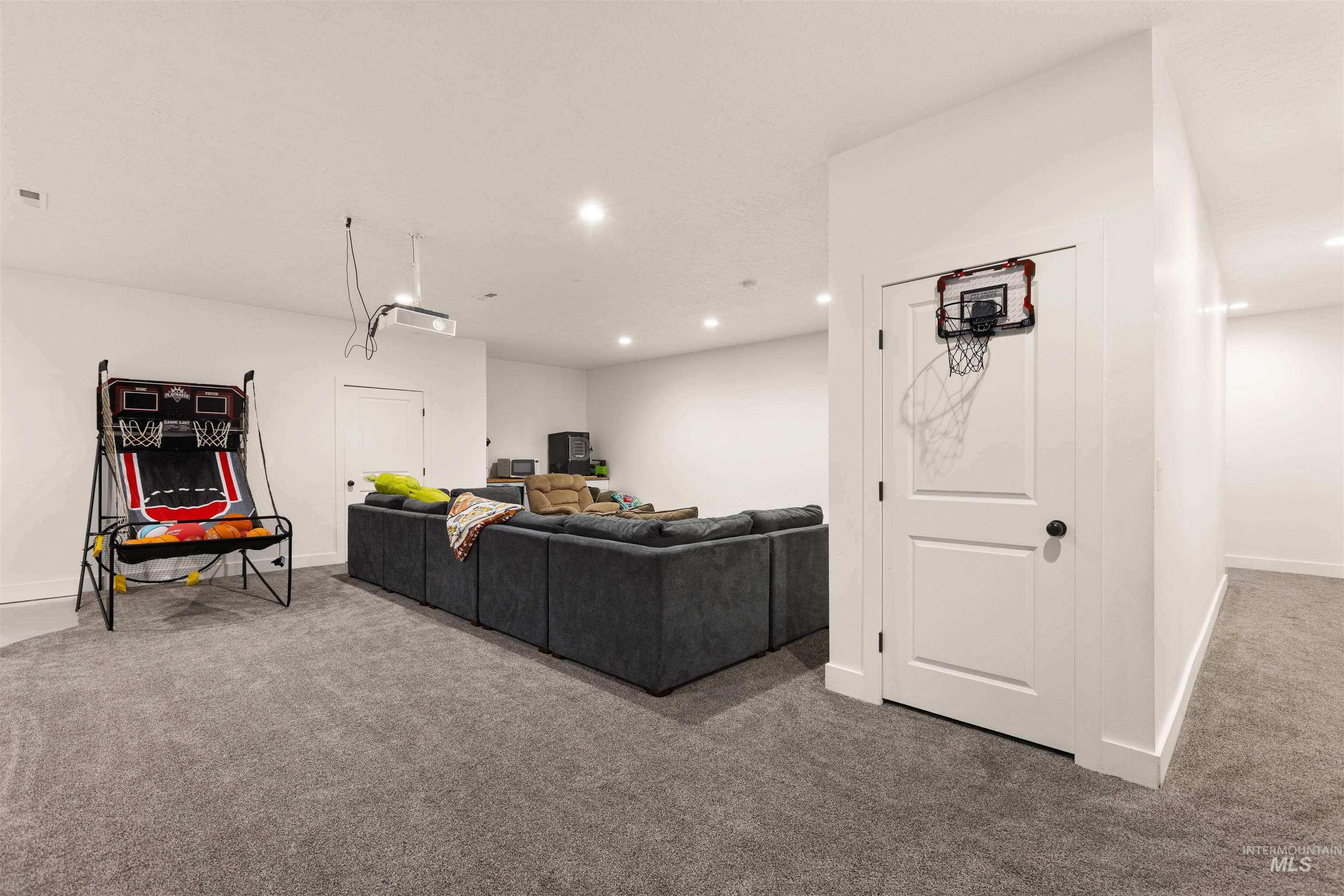 5220 West Central Road Emmett, ID 83617 - Photo 40 of 50 Carpeted living room featuring baseboards and recessed lighting