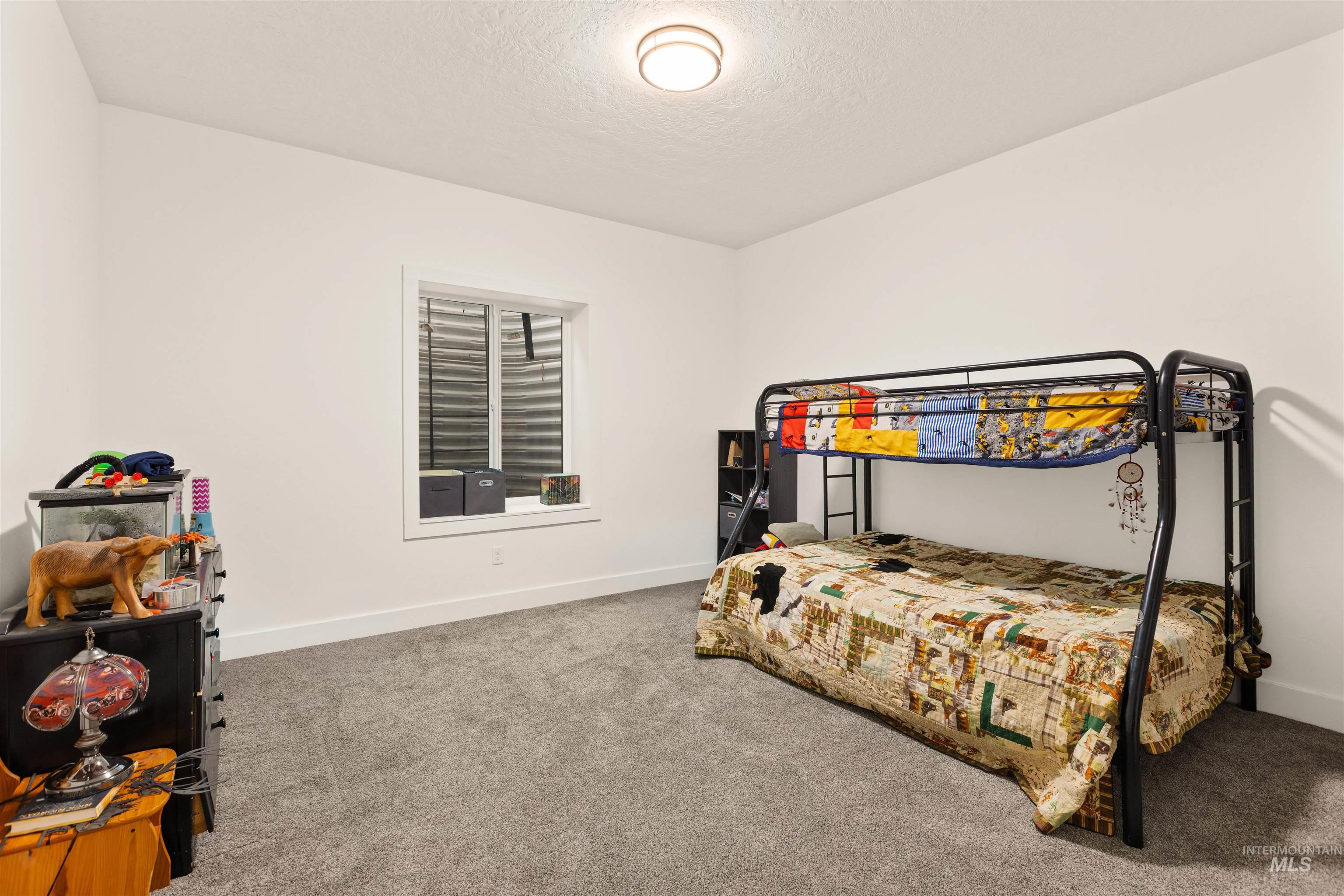 5220 West Central Road Emmett, ID 83617 - Photo 48 of 50 Bedroom with light colored carpet and a textured ceiling