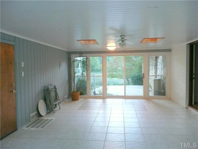 213 Bayleaf Drive Raleigh, NC 27615 - Photo 19 of 25 Nice tile floor in this large sunroom. Sliding doors lead out to patio and yard. Sun Room