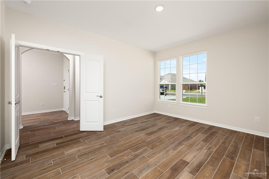 6528 Anaqua Loop McAllen, TX 78504 - Photo 2 of 11 wooden floor in an empty room with a window
