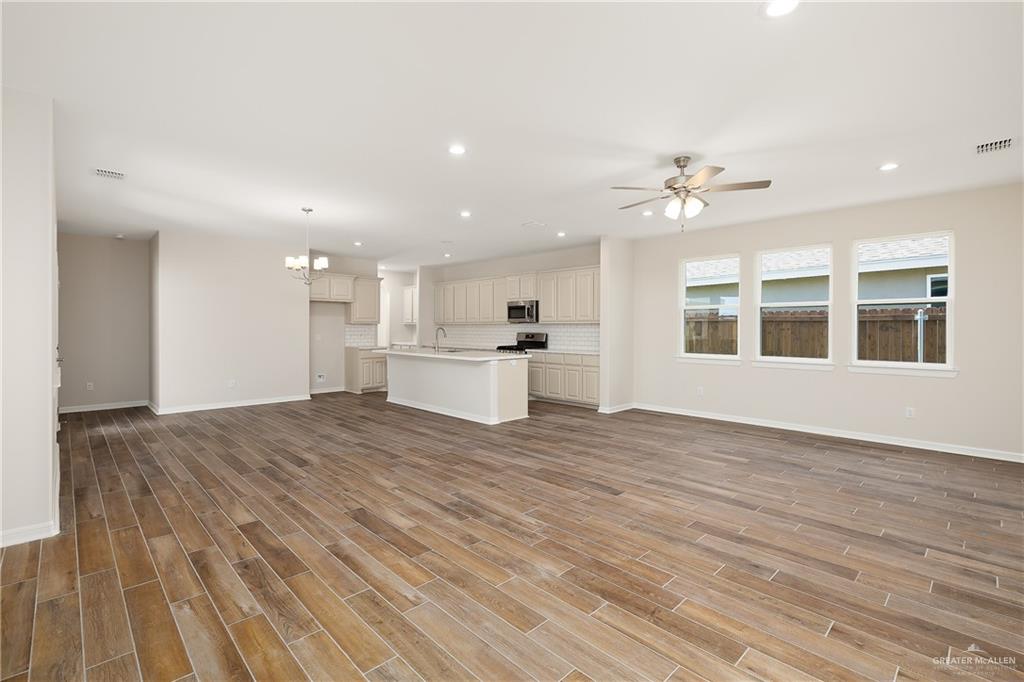 6528 Anaqua Loop McAllen, TX 78504 - Photo 3 of 11 a view of an empty room with a window and wooden floor