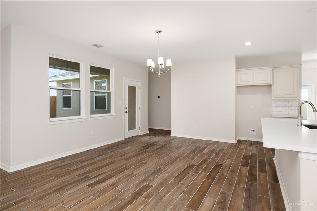 6528 Anaqua Loop McAllen, TX 78504 - Photo 4 of 11 a view of a room with wooden floor and cabinets