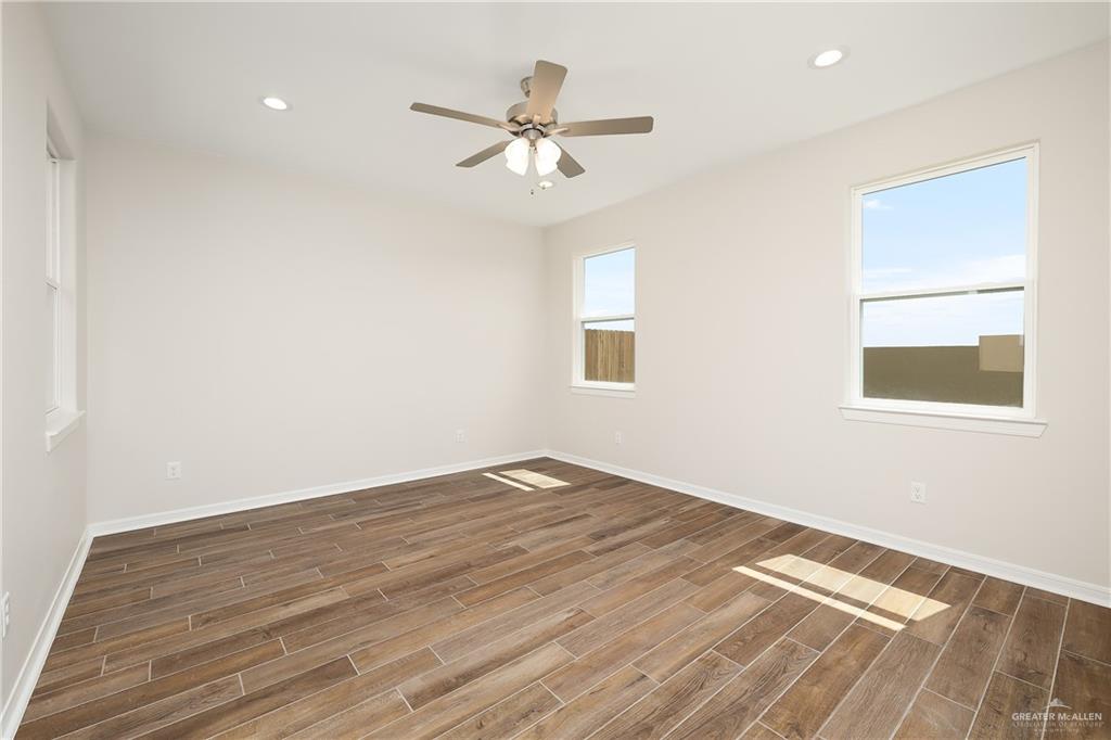 6528 Anaqua Loop McAllen, TX 78504 - Photo 7 of 11 a view of a room with wooden floor and a ceiling fan
