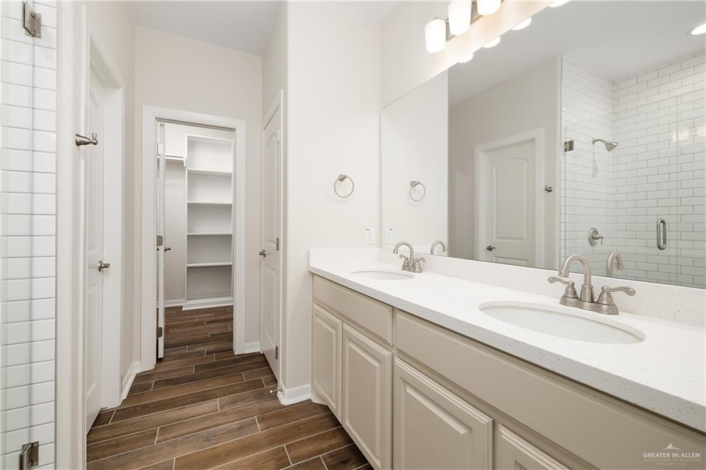 6528 Anaqua Loop McAllen, TX 78504 - Photo 8 of 11 a bathroom with a double vanity sink and a mirror