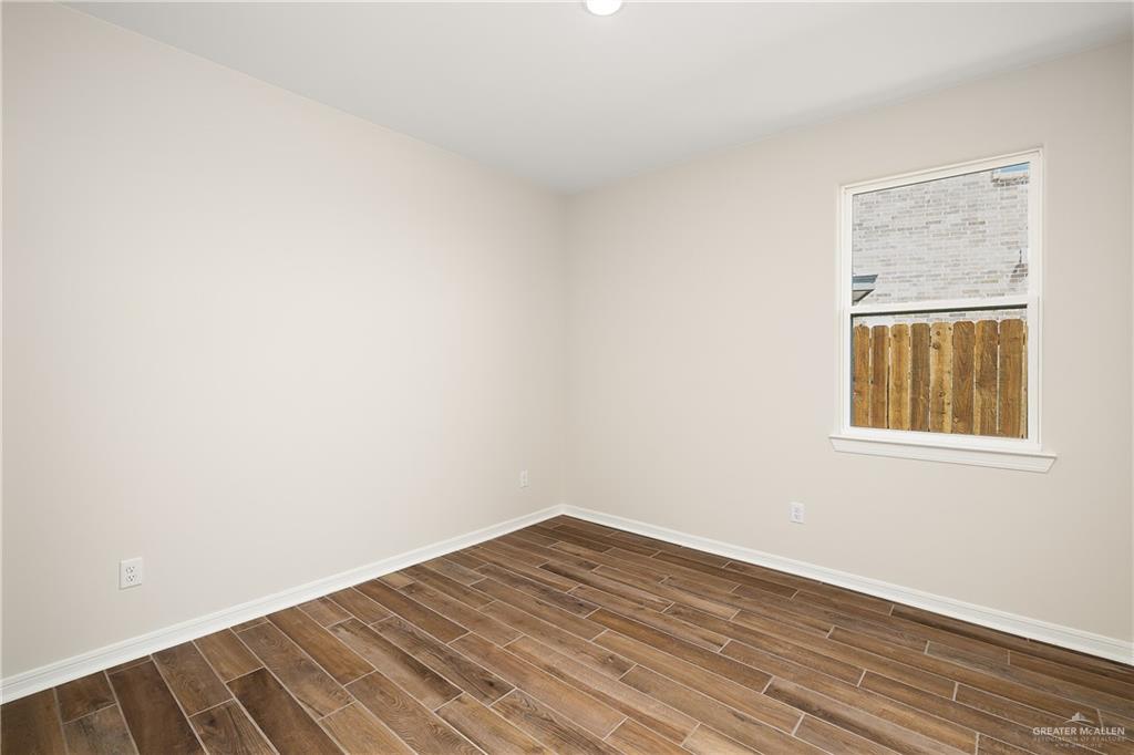 6528 Anaqua Loop McAllen, TX 78504 - Photo 9 of 11 a view of an empty room with wooden floor and a window