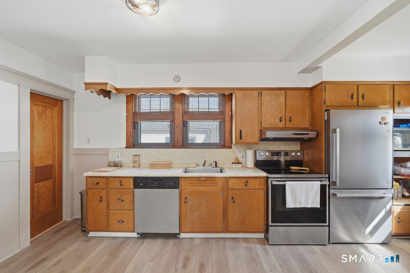 443 Highland Avenue Waterbury, CT 06708 - Photo 9 of 24 a kitchen with a stove a sink and a refrigerator