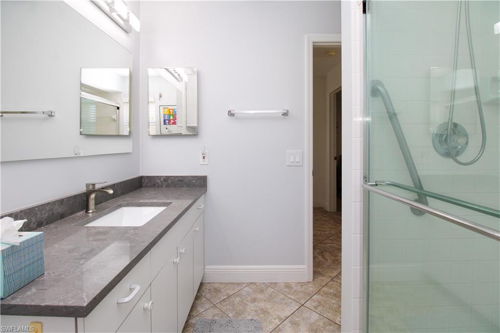 516 Gordonia Road Naples, FL 34108 - Photo 23 of 50 a bathroom with a granite countertop sink and a mirror