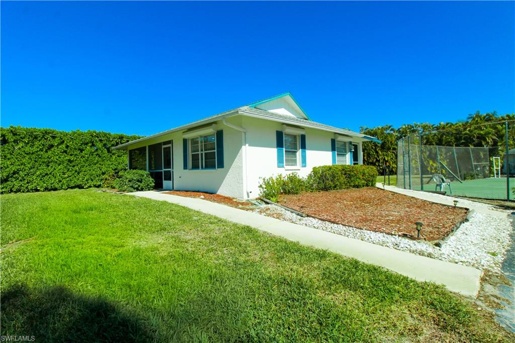 516 Gordonia Road Naples, FL 34108 - Photo 8 of 50 a front view of a house with a yard