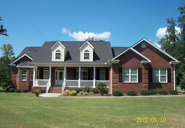 6323 Rogers Road Lizella, GA 31052 - Photo 1 of 1 a front view of a house with a garden