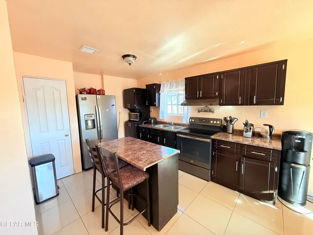 a dining room with furniture and a window