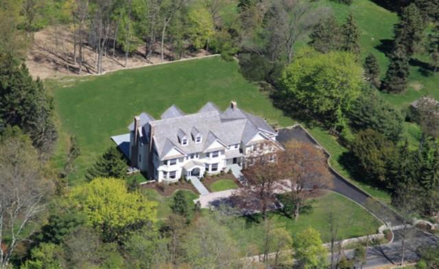 an aerial view of a house with a yard basket ball court and outdoor seating