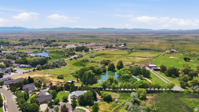 2190 750 West Perry, UT 84302 - Photo 39 of 42 Expansive rural landscape featuring a private pond, mature trees, and agricultural fields