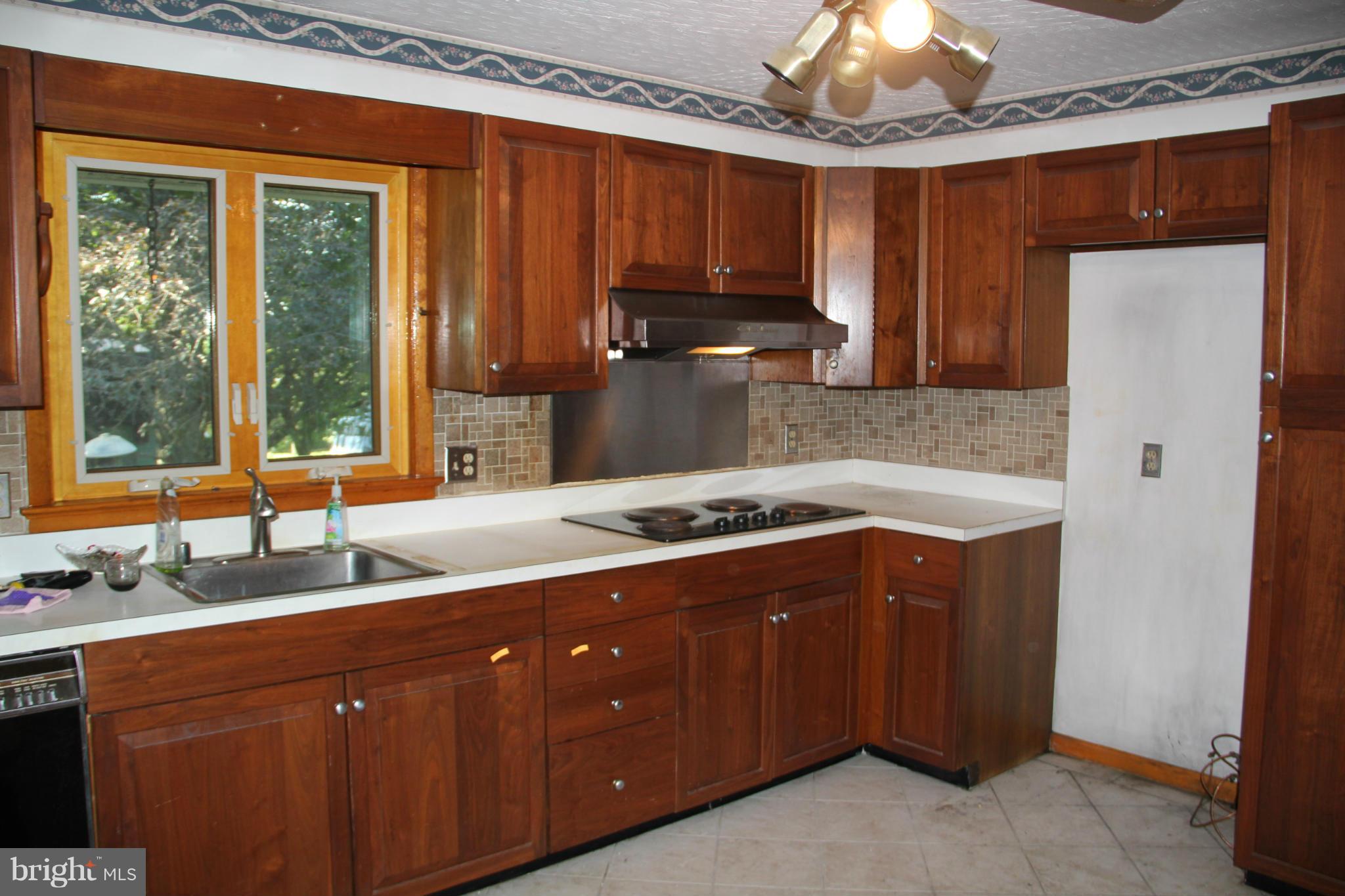 9913 Fox Hill Road Perry Hall, MD 21128 - Photo 11 of 24 a kitchen with stainless steel appliances granite countertop a stove a sink dishwasher and a refrigerator with wooden cabinets