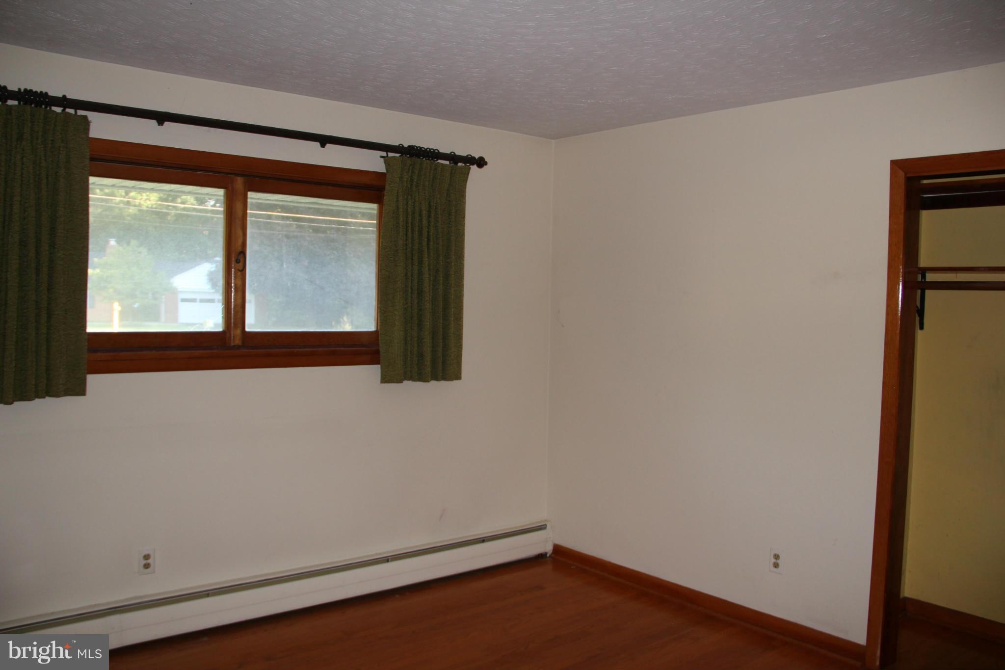 9913 Fox Hill Road Perry Hall, MD 21128 - Photo 15 of 24 a view of an empty room with wooden floor and a window