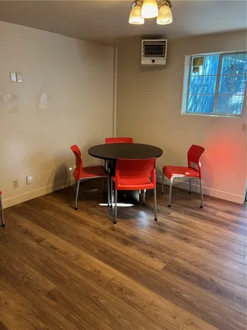 a patio with table and chairs with wooden fence