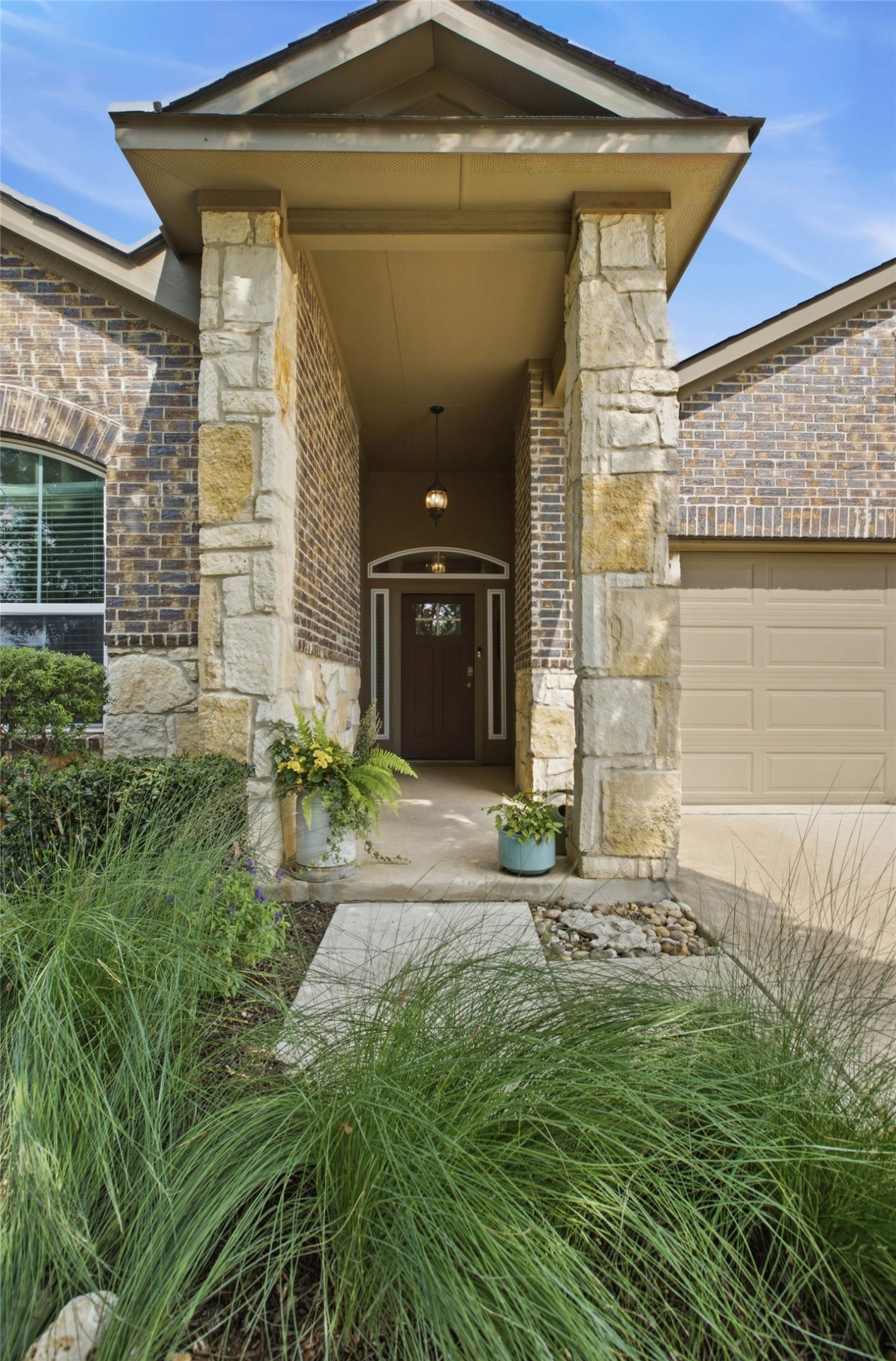 2413 Bridges Ranch Road Georgetown, TX 78628 - Photo 2 of 31 A welcoming entry features sturdy stone and brickwork, enhancing the home's curb appeal.